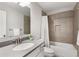 Bathroom featuring a single sink vanity, decorative mirror, and a tub-shower combo at 505 Flyingbolt Run, Canton, GA 30115