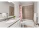 Bathroom featuring a single sink vanity, decorative mirror, and a tub-shower combo at 505 Flyingbolt Run, Canton, GA 30115