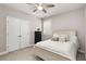 Bedroom featuring neutral walls, carpeted floor, a ceiling fan, and a large closet at 505 Flyingbolt Run, Canton, GA 30115
