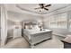 Bright bedroom with tray ceilings, a large window, and an elegant bed with plush bedding at 505 Flyingbolt Run, Canton, GA 30115