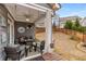 Cozy covered patio features a seating area and decor, perfect for relaxing and enjoying the fenced backyard at 505 Flyingbolt Run, Canton, GA 30115