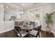 Cozy dining area boasts a round table with seating and natural light filtering through the windows at 505 Flyingbolt Run, Canton, GA 30115