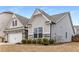 Side exterior showcasing the home's stone accents, garage, and landscaping at 505 Flyingbolt Run, Canton, GA 30115