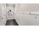 Hallway with dark hardwood floors, coat hooks, and white wainscoting at 505 Flyingbolt Run, Canton, GA 30115