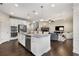 Open-concept kitchen with stainless steel appliances, granite island, and sightlines to the living room at 505 Flyingbolt Run, Canton, GA 30115