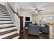 Inviting living room with hardwood floors, neutral walls, ceiling fan and an open floor plan for seamless flow at 505 Flyingbolt Run, Canton, GA 30115