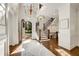 Bright and spacious entryway with hardwood floors, chandelier, and staircase at 4706 Powers Ferry Rd, Atlanta, GA 30327