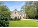 Brick house with landscaped lawn and gated entrance at 4706 Powers Ferry Rd, Atlanta, GA 30327