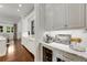 Spacious kitchen with white cabinets, marble countertops, and hardwood floors at 4706 Powers Ferry Rd, Atlanta, GA 30327