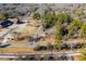Aerial view showcasing a house nestled in a wooded area near a road at 6531 Temple St, Lithia Springs, GA 30122