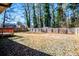 Large backyard with wooden deck and fenced perimeter at 6531 Temple St, Lithia Springs, GA 30122
