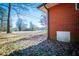 Exterior basement access with brick wall and white door at 6531 Temple St, Lithia Springs, GA 30122