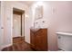Updated bathroom with wood vanity and toilet at 6531 Temple St, Lithia Springs, GA 30122