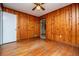Bedroom with wood paneled walls and hardwood floors at 6531 Temple St, Lithia Springs, GA 30122
