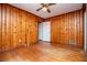 Bedroom with wood paneled walls and hardwood floors at 6531 Temple St, Lithia Springs, GA 30122