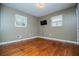 Well-lit bedroom with hardwood floors and two windows at 6531 Temple St, Lithia Springs, GA 30122