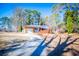 Ranch home with a long driveway and mature trees at 6531 Temple St, Lithia Springs, GA 30122