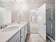 Bathroom featuring double sinks and a separate shower; bedroom can be seen in the background at 7116 Fringe Flower Dr # 19, Austell, GA 30168