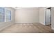 Bedroom featuring neutral carpet, base molding, and a bright window at 7116 Fringe Flower Dr # 19, Austell, GA 30168