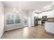 Bright dining area featuring hardwood floors, a chandelier, and a door to the backyard at 7116 Fringe Flower Dr # 19, Austell, GA 30168