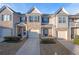 Townhome exterior featuring garage doors and a neatly landscaped front yard at 7116 Fringe Flower Dr # 19, Austell, GA 30168