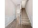 Bright hallway with hardwood flooring and a carpeted staircase at 7116 Fringe Flower Dr # 19, Austell, GA 30168