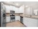 Well-equipped kitchen with stainless steel appliances, granite counter and bright lighting at 7116 Fringe Flower Dr # 19, Austell, GA 30168