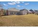 House exterior showcasing a large backyard at 215 Prominent Loop, Mcdonough, GA 30253