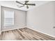 Bright bedroom with hardwood floors and ceiling fan at 215 Prominent Loop, Mcdonough, GA 30253