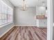 Bright dining room with hardwood floors and chandelier at 215 Prominent Loop, Mcdonough, GA 30253