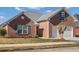 Brick ranch house with attached garage and manicured lawn at 215 Prominent Loop, Mcdonough, GA 30253