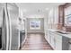 Modern kitchen with stainless steel appliances and white cabinetry at 215 Prominent Loop, Mcdonough, GA 30253