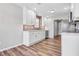 Kitchen with white cabinets, quartz countertops, and tile backsplash at 215 Prominent Loop, Mcdonough, GA 30253