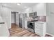 Modern kitchen with stainless steel appliances and white cabinets at 215 Prominent Loop, Mcdonough, GA 30253