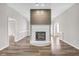 Living room with fireplace and wood-look flooring at 215 Prominent Loop, Mcdonough, GA 30253