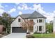 Two-story house with white exterior, dark garage door, and landscaping at 2172 Briarlake Ne Trce, Atlanta, GA 30345