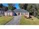 Brick ranch home with landscaped yard and driveway at 2820 Ashton Tree Ct, Dacula, GA 30019