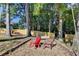 Fire pit area with red chairs and a swing at 2820 Ashton Tree Ct, Dacula, GA 30019