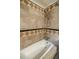 Bathroom with beige tile, shower, and bathtub at 3318 Northcrest Rd # D, Atlanta, GA 30340