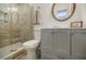 Updated bathroom features a walk-in shower, gray vanity, and modern toilet at 3318 Northcrest Rd # D, Atlanta, GA 30340