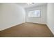 Spacious bedroom with brown carpet and large window at 3318 Northcrest Rd # D, Atlanta, GA 30340