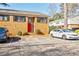 Brick townhouse with red front door and parking at 3318 Northcrest Rd # D, Atlanta, GA 30340