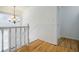 Upstairs hallway with hardwood floors and wainscoting at 3318 Northcrest Rd # D, Atlanta, GA 30340