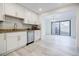 Updated kitchen with stainless steel appliances and granite countertops, open to dining area at 3318 Northcrest Rd # D, Atlanta, GA 30340