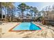Community pool with lounge chairs and surrounding brick fencing at 3318 Northcrest Rd # D, Atlanta, GA 30340