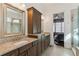 Luxurious bathroom featuring double sinks, granite countertops, and a glass-enclosed shower at 7540 Cordery Rd, Cumming, GA 30040