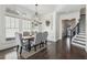 Spacious dining room with farmhouse table, chandelier, and hardwood floors at 7540 Cordery Rd, Cumming, GA 30040