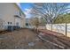 Side yard with a small patio, landscaping, and a white fence at 2885 Field Spring Dr, Lithonia, GA 30058