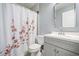 Clean bathroom with gray vanity, floral shower curtain, and tiled floor at 2885 Field Spring Dr, Lithonia, GA 30058