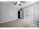 Bedroom with gray walls, carpet flooring, and double doors at 2885 Field Spring Dr, Lithonia, GA 30058
